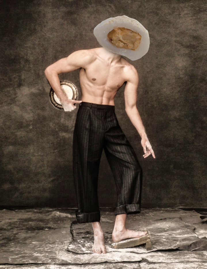 shirtless male in pinstripe slacks holding silver plate